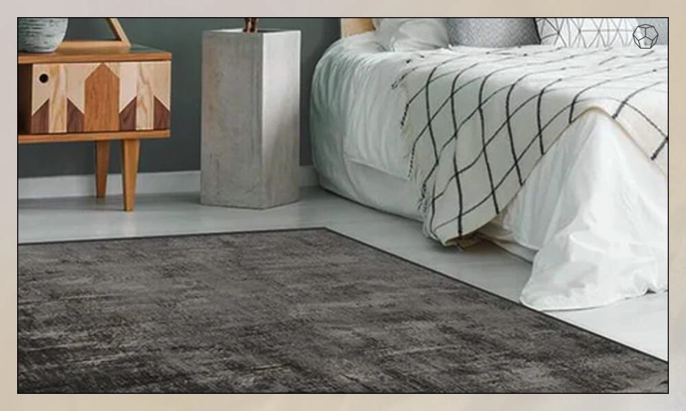 Dark grey rug placed on one side of the bed
