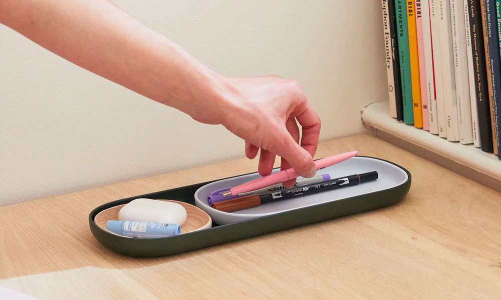 Minimalist Office organizer with airpods and pens in it