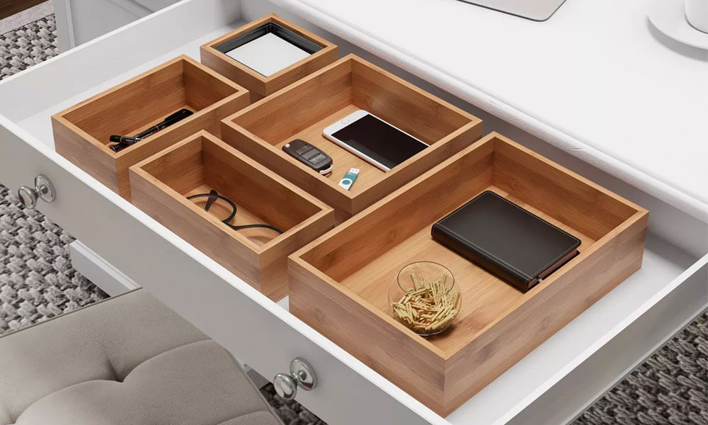 Five Modular Natural Wood Bamboo Space Saver Tray with personal objects in them