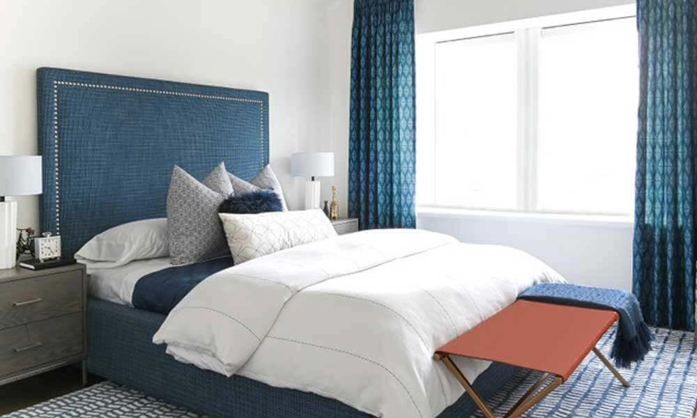 Navy Upholstered Bed Frame in a cozy bedroom with sidetables, a window and a matching rug