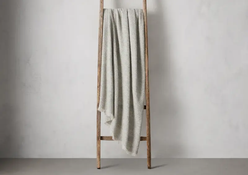 Fog throw blanket holding in a wooden ladder