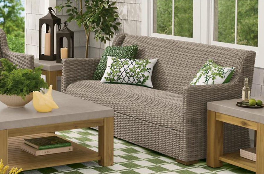 Wicker outdoor set without cushions and blue throw pillows
