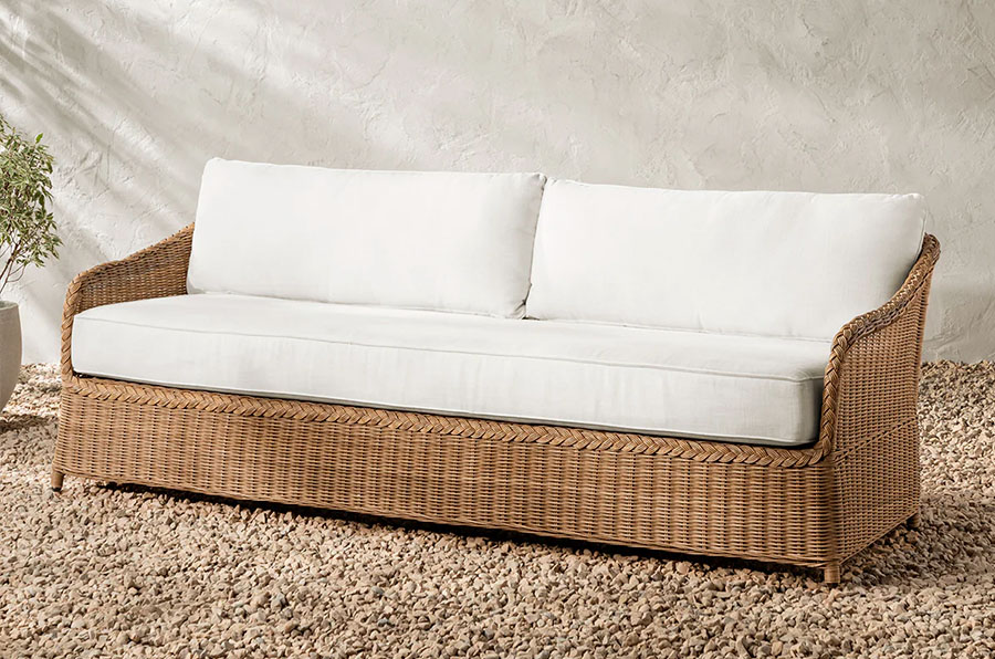 Modern wicker sofa with white cushions