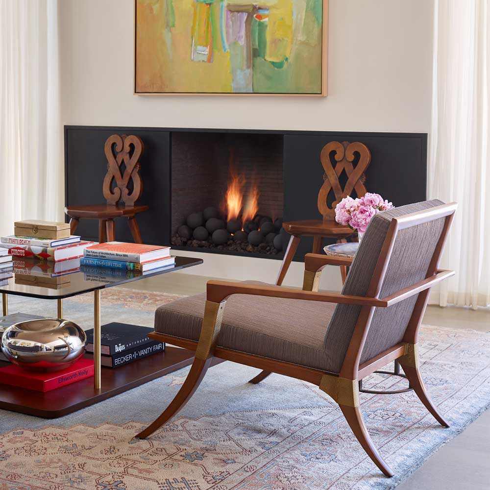 Mid century living room with a wooden accent chair with grey seat anc back cushions
