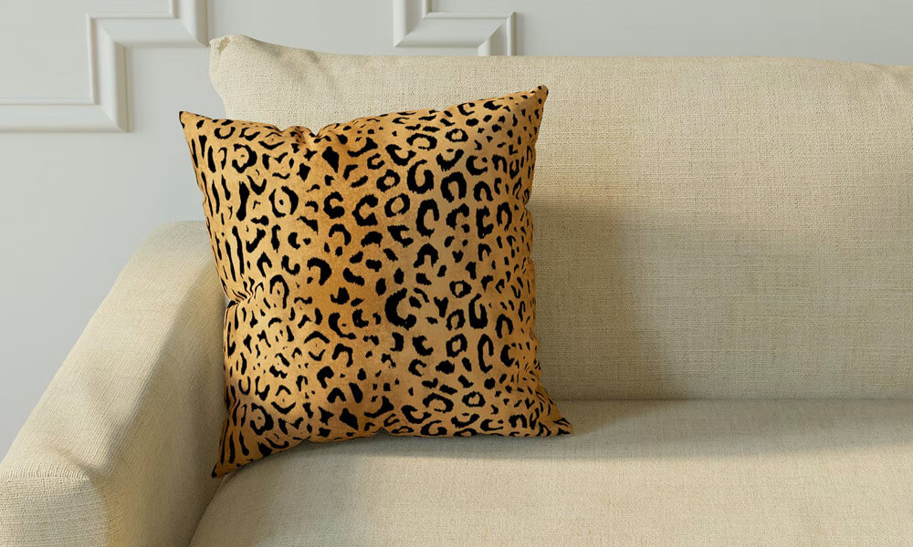 Leopard Throw Pillow in a beige couch