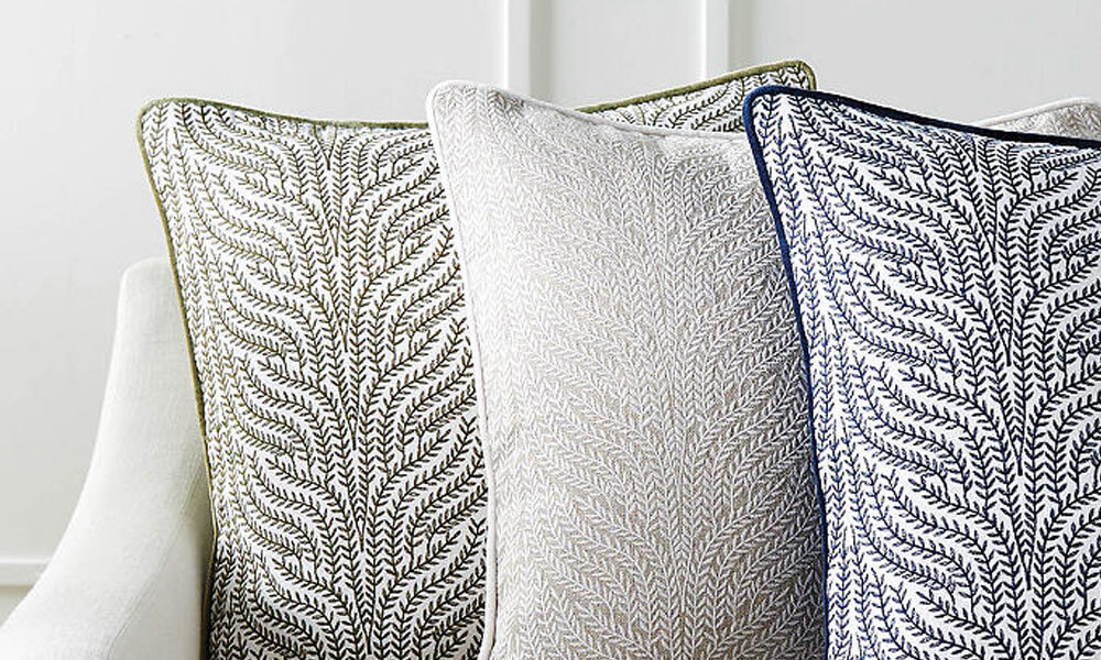 Three decorative pillows with unique and patterned designs