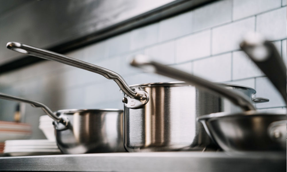 A set of silver pans and pots