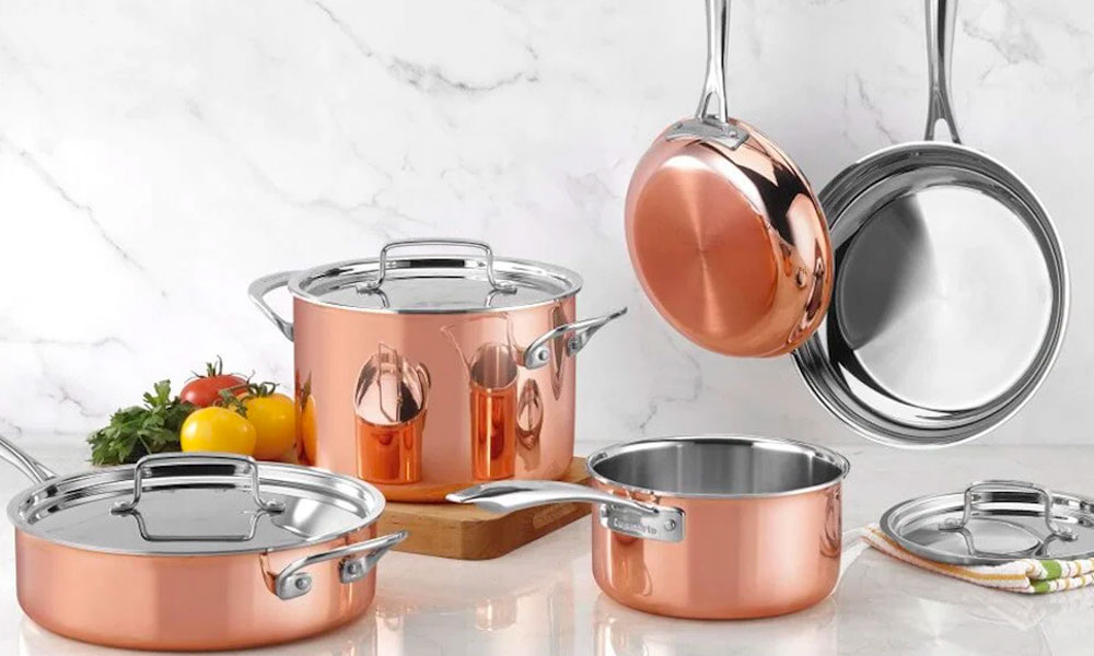 A stunning bronze copper cookware set featuring various pans and matching lids,