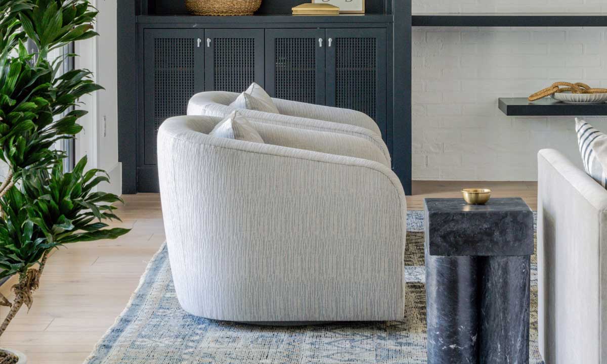 Two light gray barrel chairs in a living room