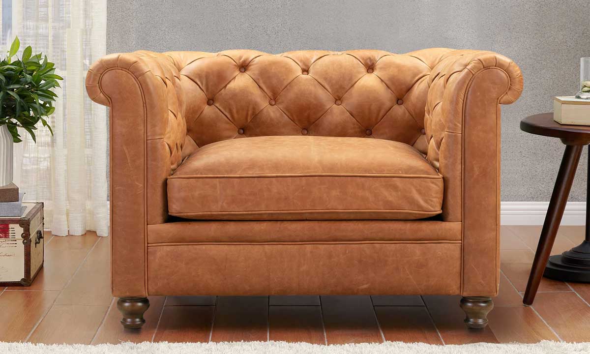 Brown leather lounge chair with small wooden legs