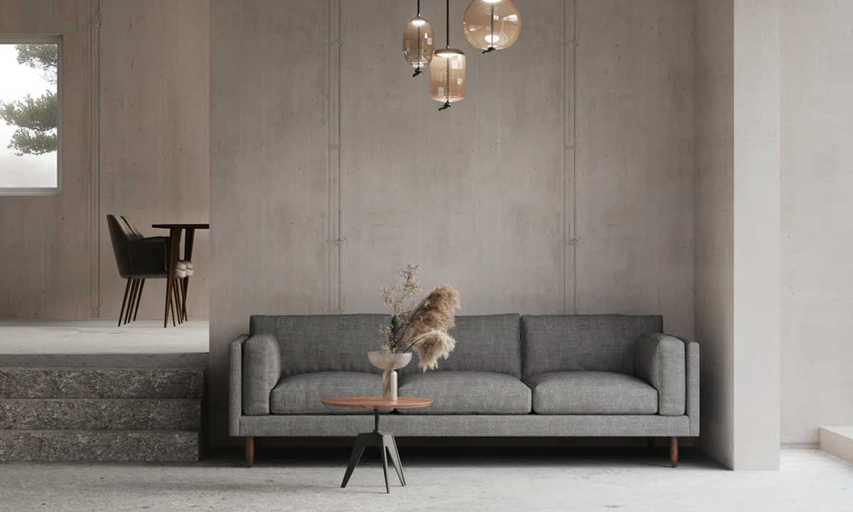 Minimalist grey upholstered sofa with wooden legs and a small wooden rounded coffee table