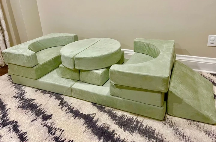 light green kid play couch with eleven pieces in a living space with a black and white rug