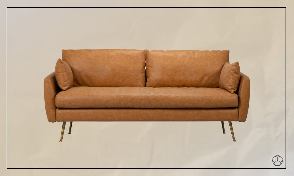 Brown leather sofa with thin wooden legs and two brown leather throw pillows