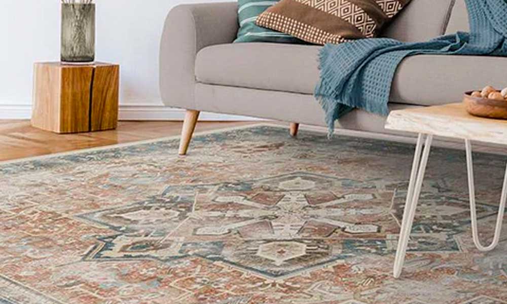 Bohemian rug in a living room under a sofa and a coffee table