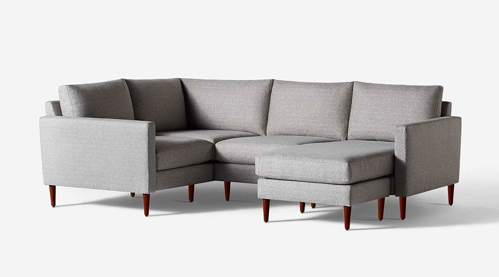 Grey upholstered corner sectional sofa with wooden legs
