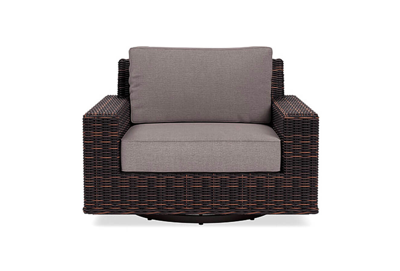 Dark brown wicker rocker chair with grey cushions 