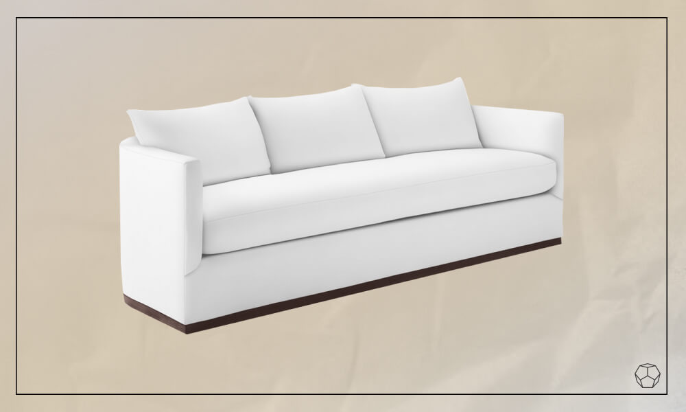white upholstered sofa with a subtle curved design and a low profile