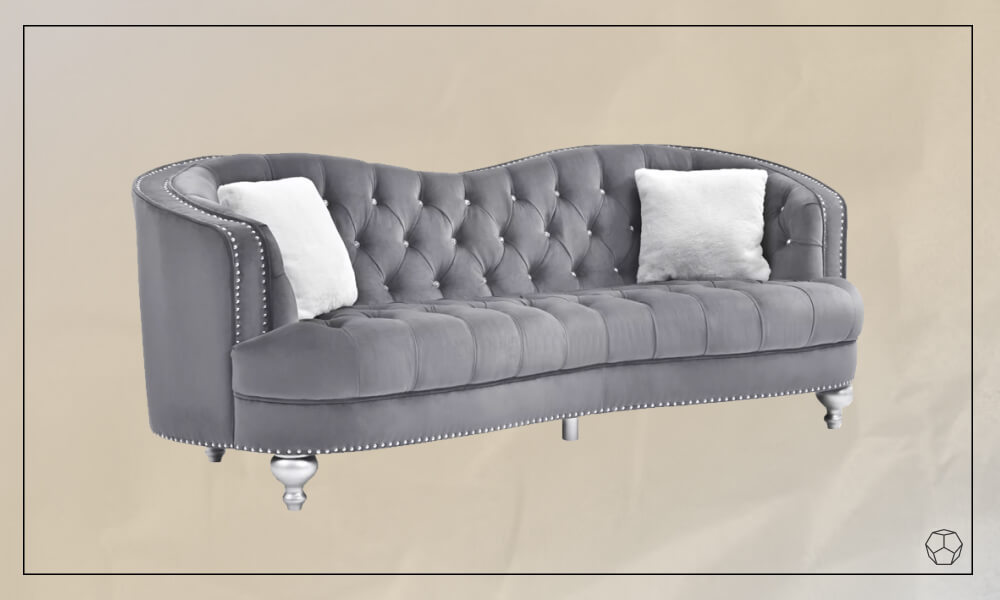 Chesterfield style curved sofa with an old school glamour in grey upholstery