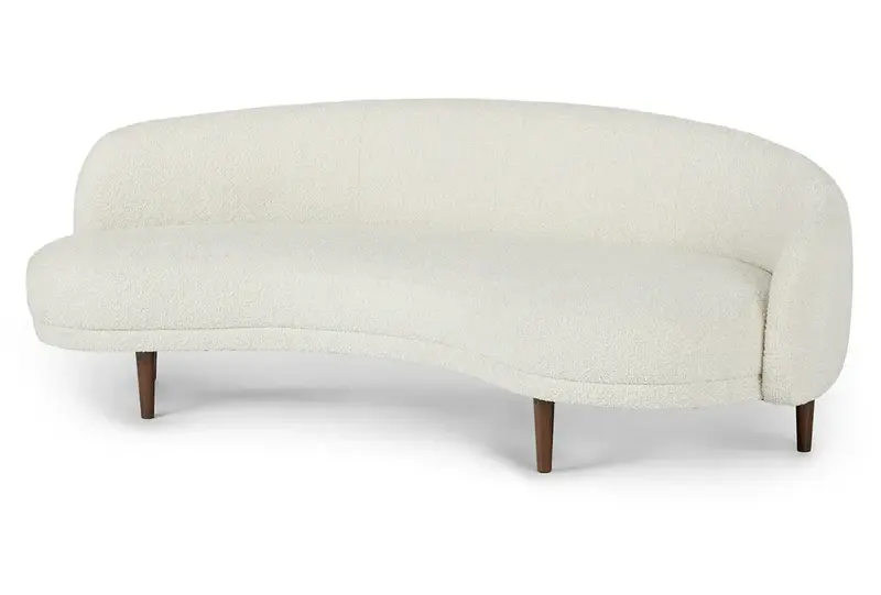 white curved sofa with wooden legs