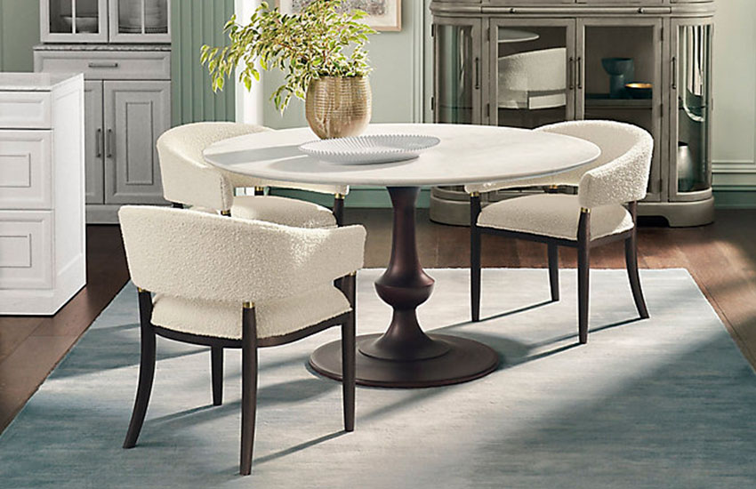 Tulip Pedestal Dining Table and upholstered white chairs
