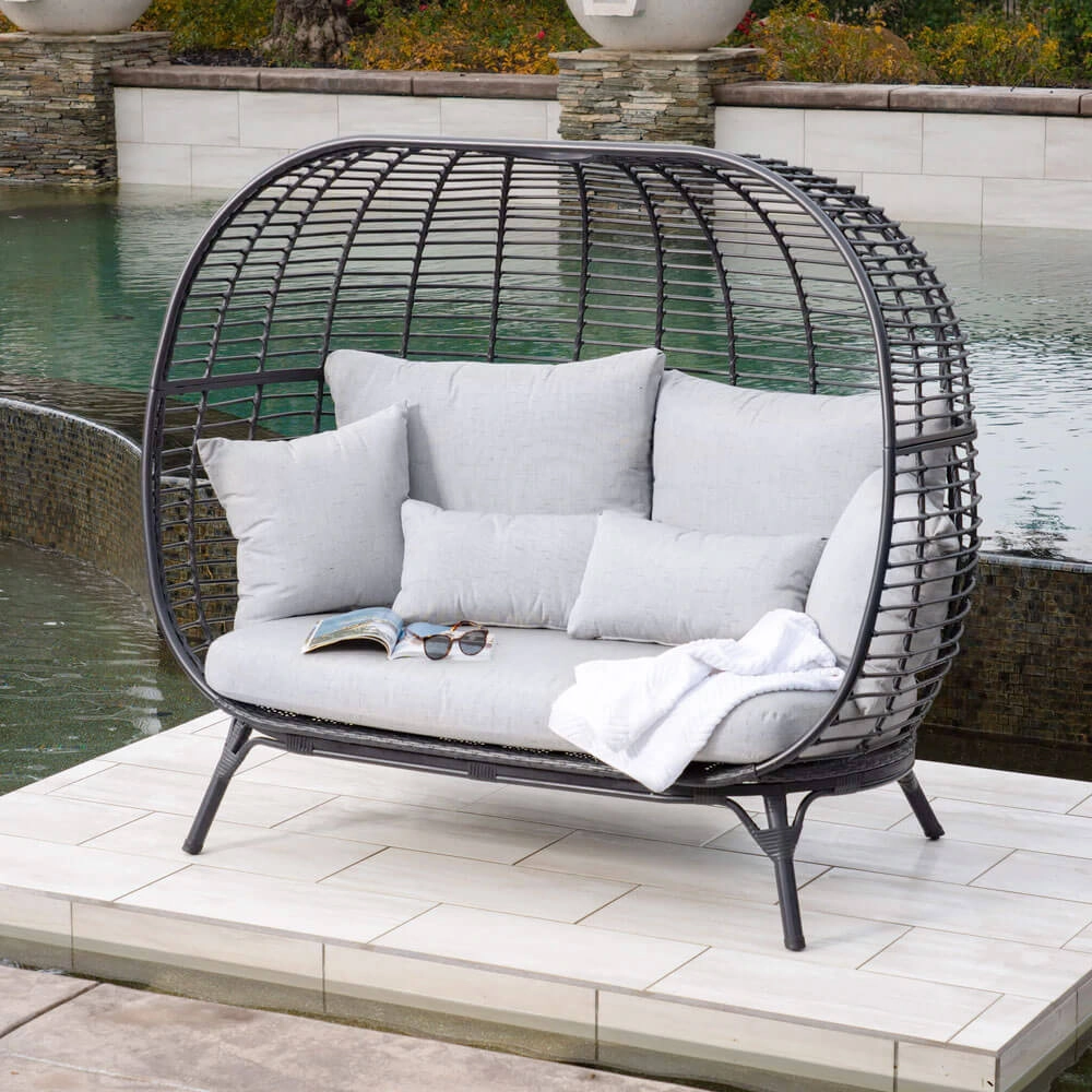 Loveseat with woven matte black outer shell and grey cushions
