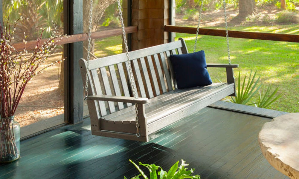 Wooden Porch Swing with one dark blue cushion