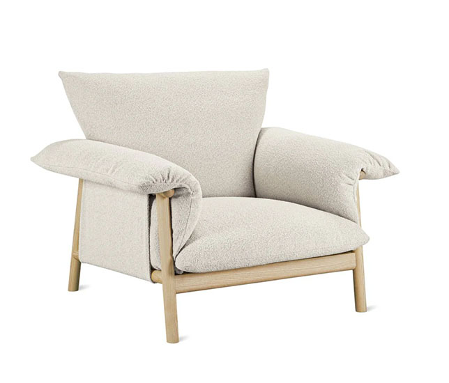 Arm chair with wooden legs and white fluffy upholstery