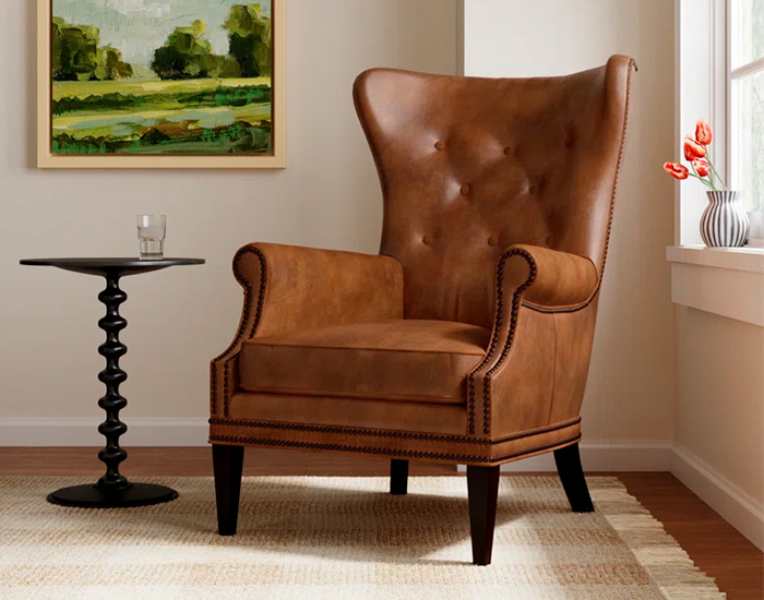 Brown Leather Upholstered Wingback Accent Chair in a room with tall coffee table