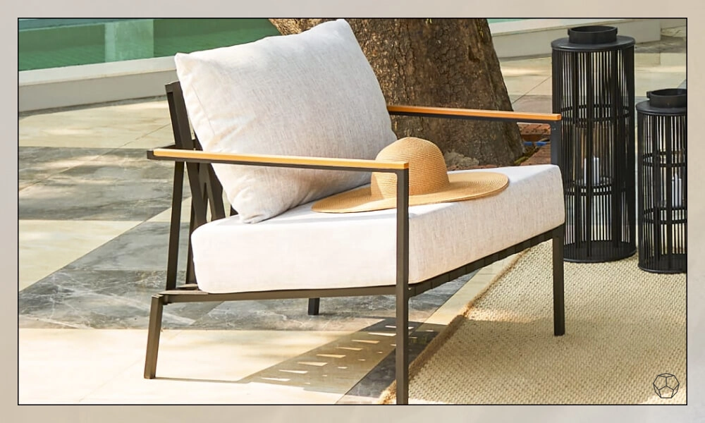 Black framed Lounge Chair with white back and seat cushions in a patio near a pool
