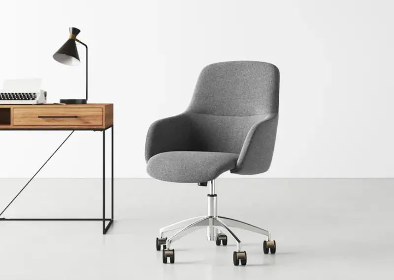 grey upholstered office chair with a five-legged wheelbase near a wooden desk