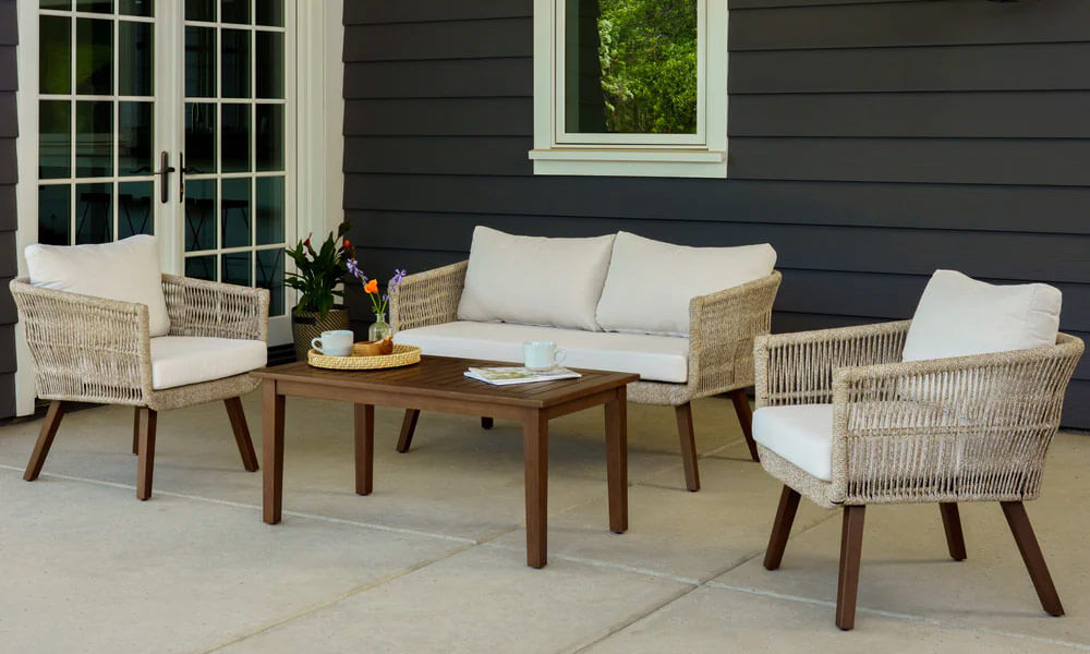 Patio 4-Piece Woven Seating Set feturing white cushions and a wooden coffee table