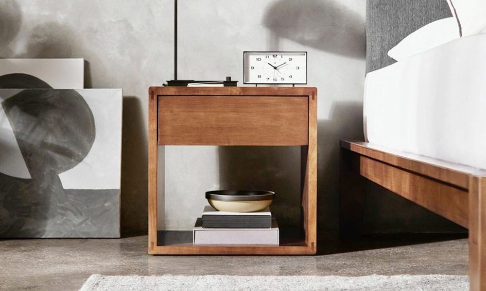 Wooden nightstand with one drawer on one side of the bed