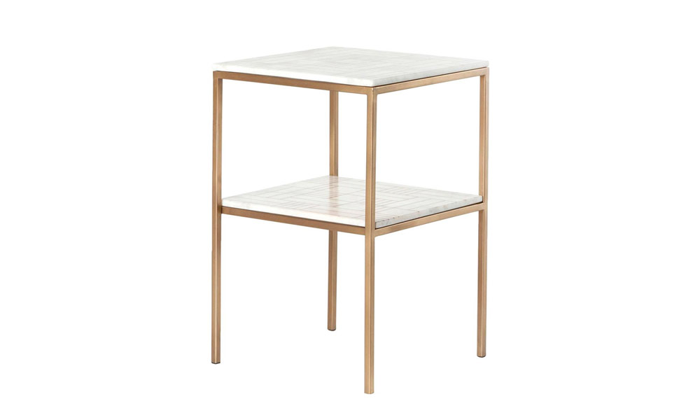 A white marble side table with elegant gold legs