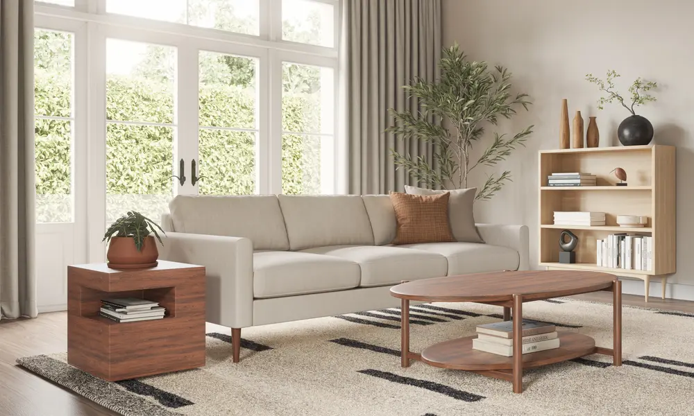 White sofa with wooden legs in a living room, a wooden coffee table and sidetables and a rug