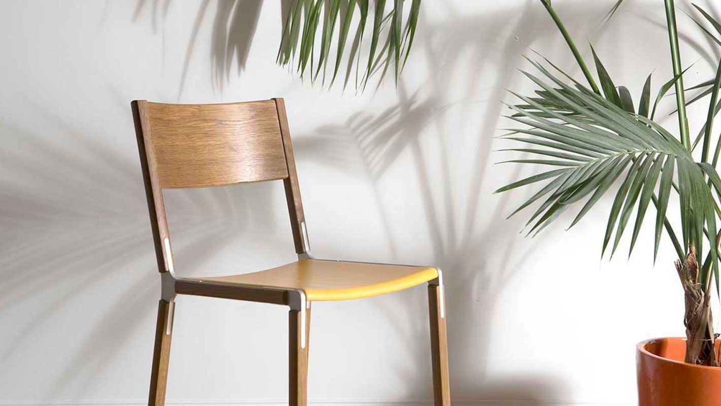 Wooden Counter Stool next to a palm tree