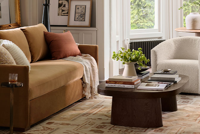 Brown upholstered sofa with wooden legs in a light gray rug in a living room
