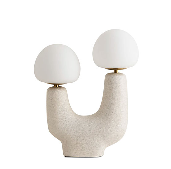U-shaped Lamp that looks like a smile with two eyes. The base is resin with Sand Glaze and has two white bulbs