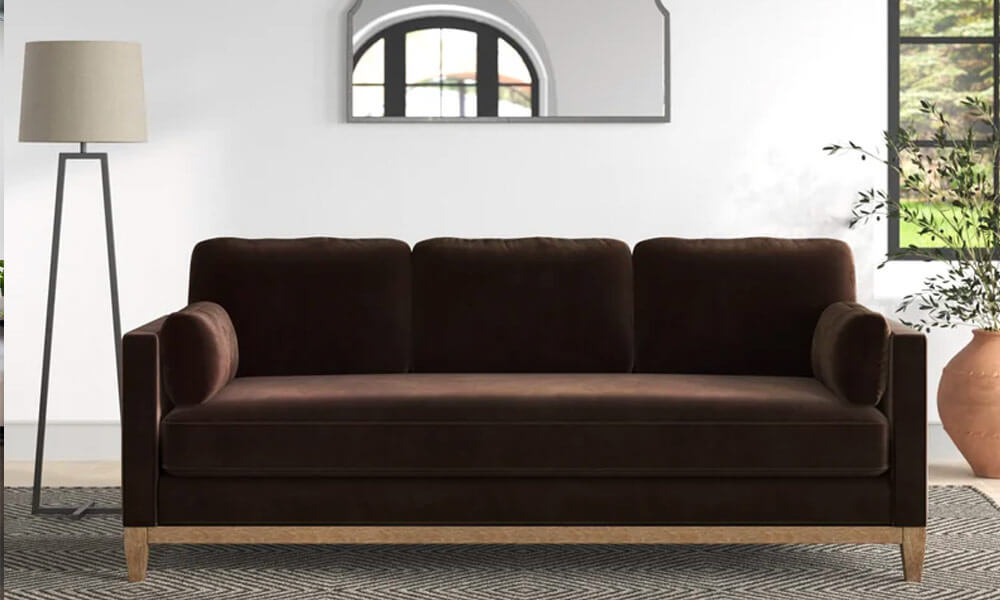Dark brown Upholstered Sofa with wooden base and legs in a modern living space with a floor lamp