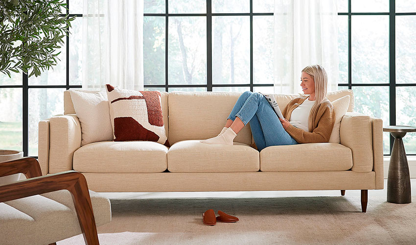 Woman on white sofa from a box