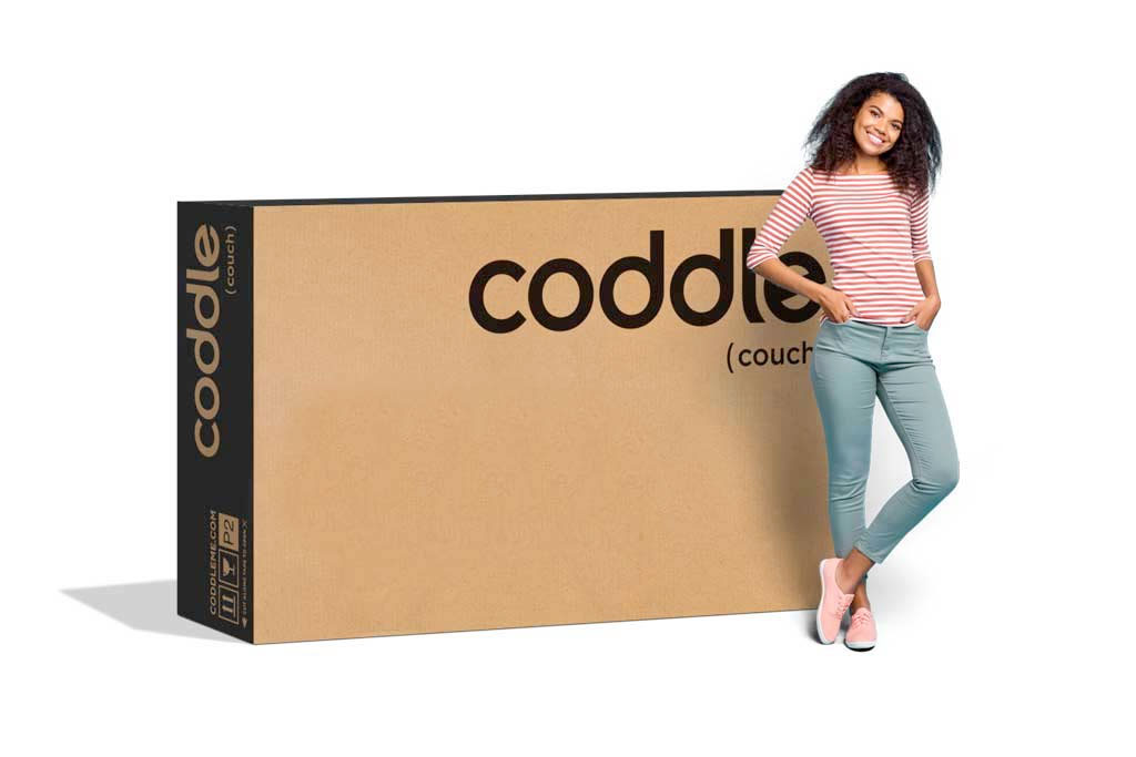 Woman standing with a big box behind her