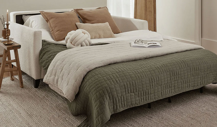 Sleeper sofa ready for night with pillows and blanket