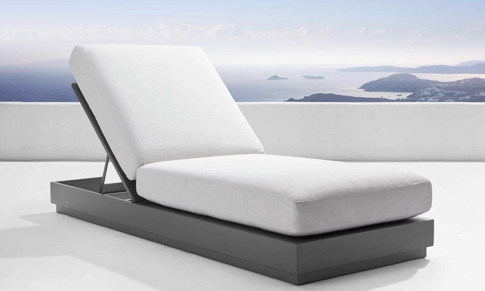 Modern aluminum outdoor chaise lounge chair with stunning landscape backdrop. 