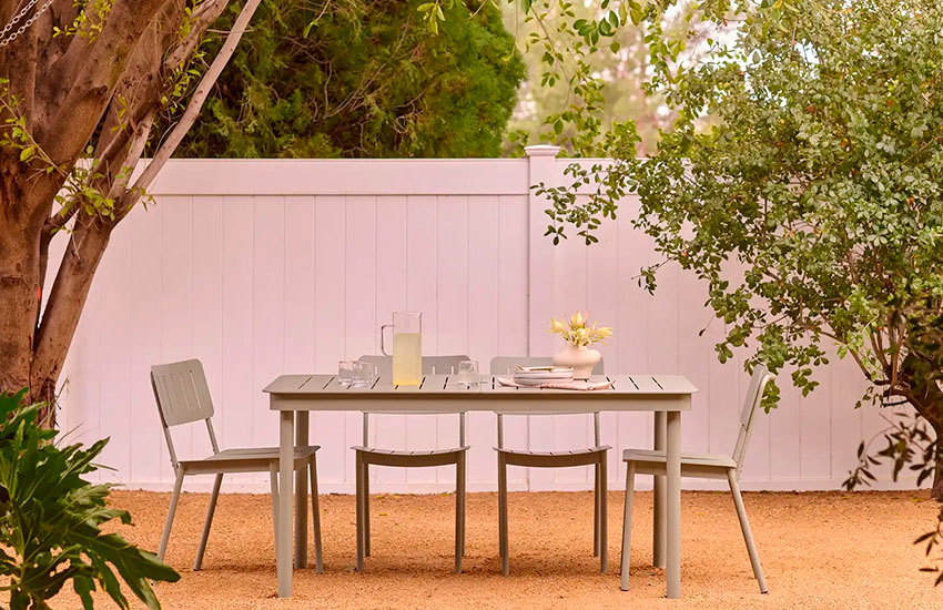 A patio furniture set featuring a table and 4 chairs