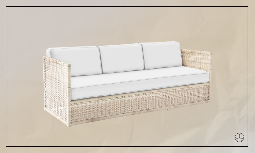 Beige wicker sofa with white cushions