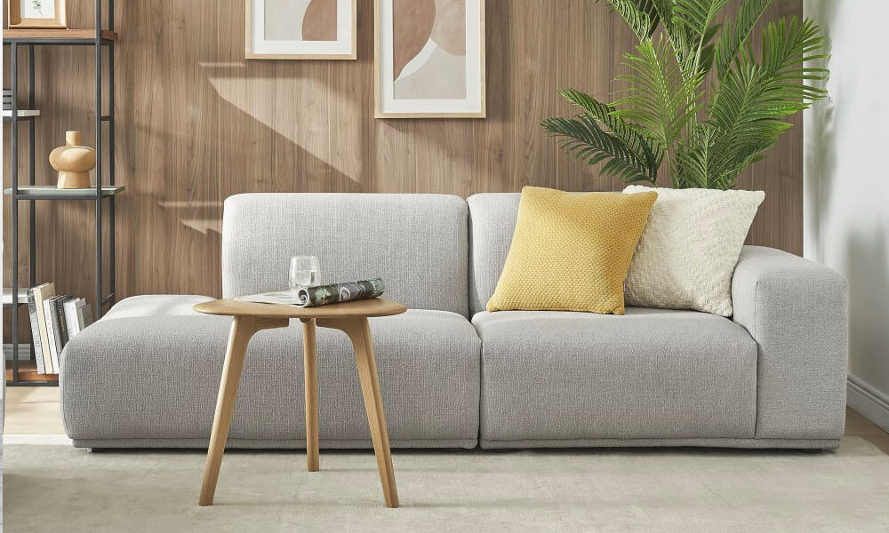 Contemporary design side chaise sofa in light grey upholstery and a modern wooden coffee table i