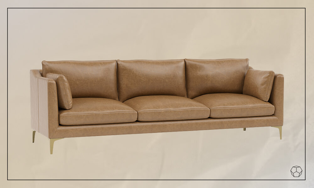 Sand leather sofa with thin legs and two matching throw pillows
