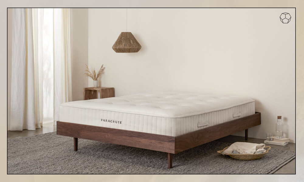 Mattress in a wooden bedframe in a modern bedroom with a grey rug