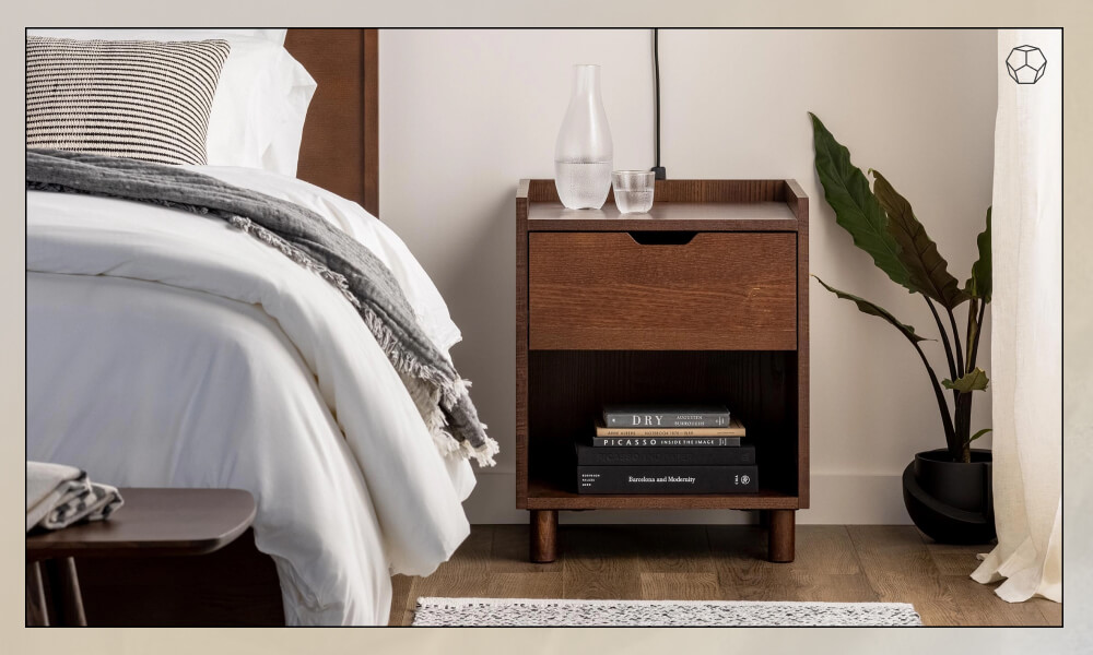 Wooden Nightstand with one drawer in one side of a wooden bedframe with grey bedding