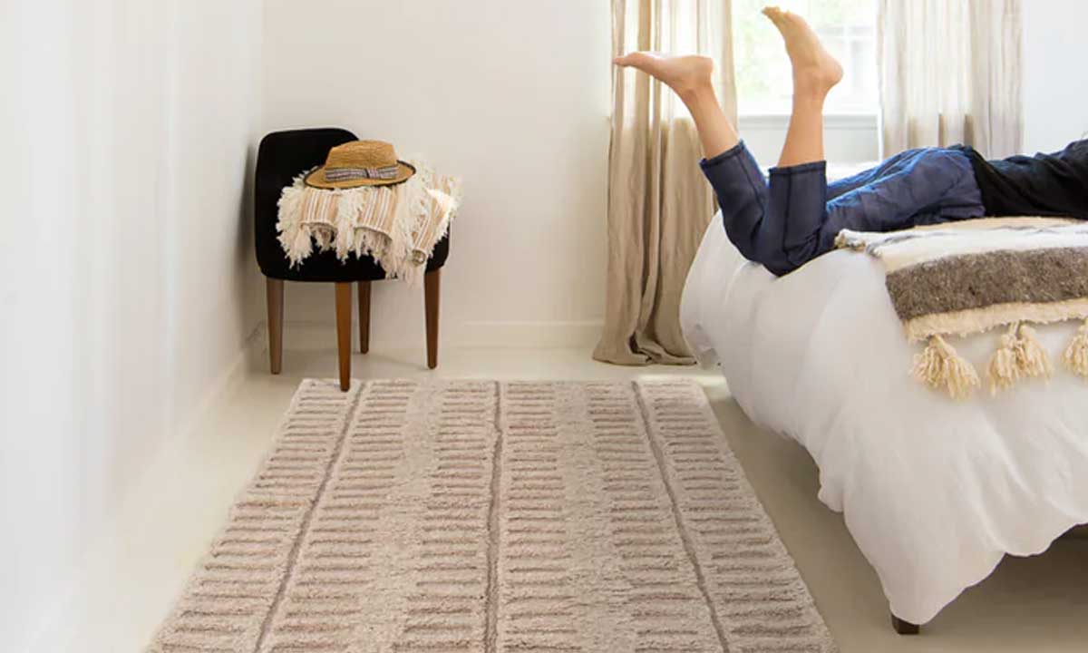 Vintage Rug near a bed with someone in it