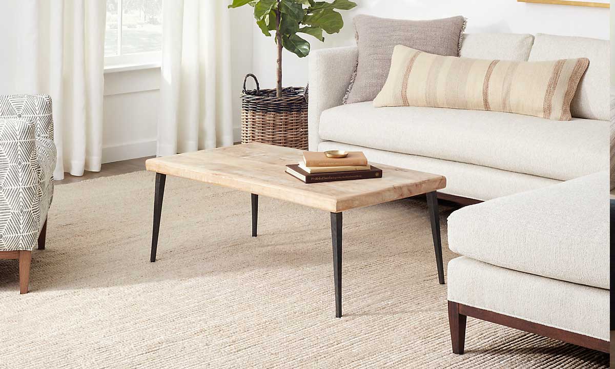 White Latte Handwoven Rug in a bright living room with a wooden coffee table